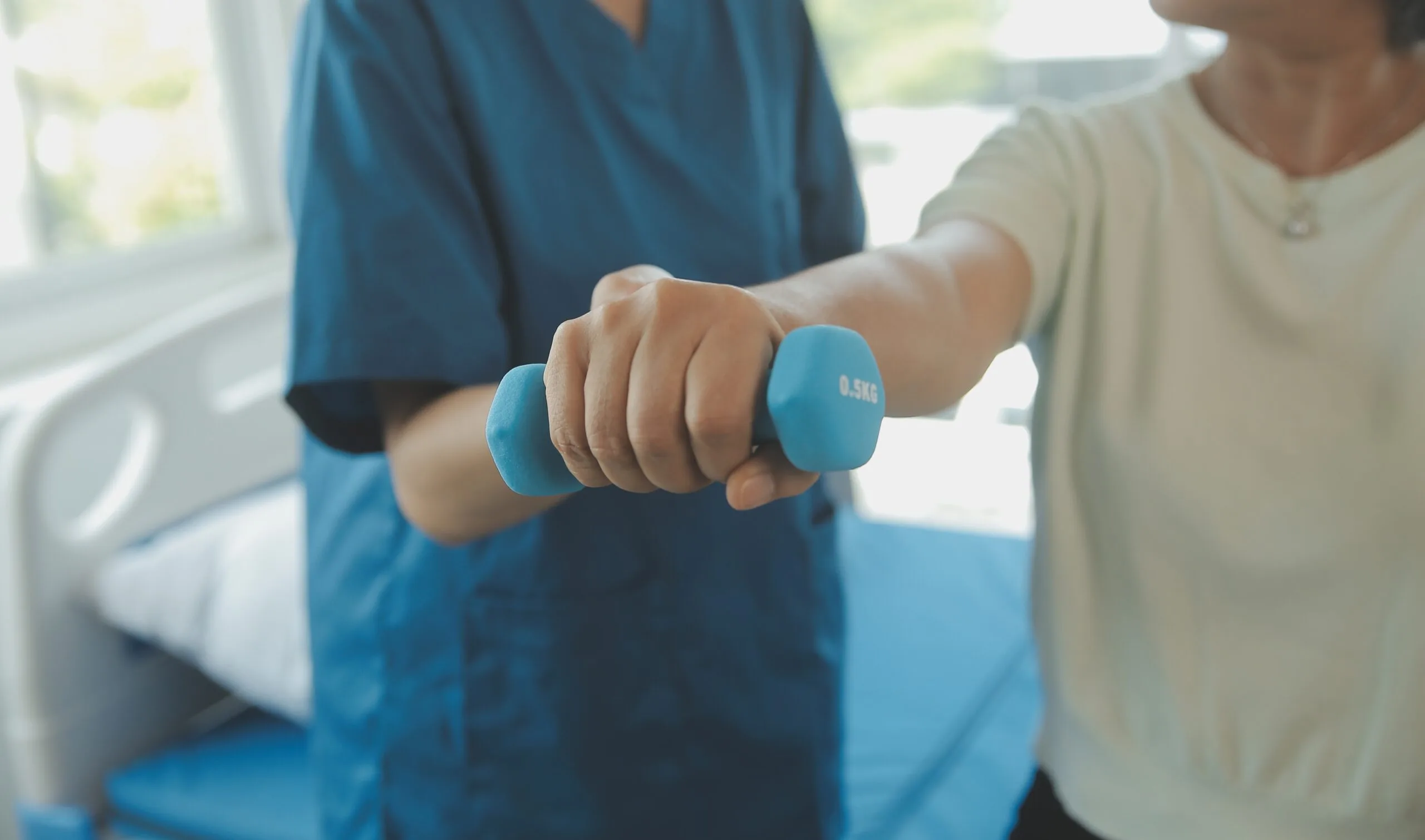 An image of a senior woman doing some physiotherapy at home after an operation